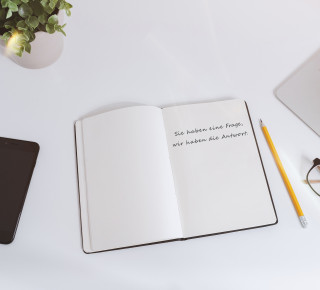 Contact Picture of an empty notepad with phone and laptop