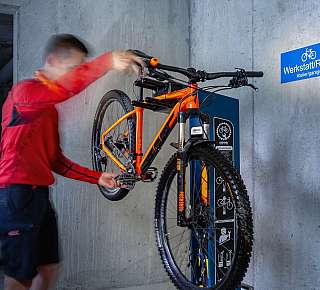 Bicycle repair on workshop wall