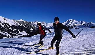 Cross-country skiers in a snowy mountain landscape