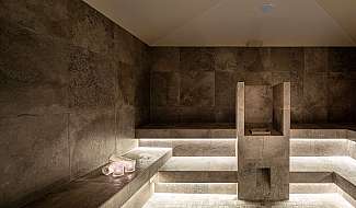 Modern sauna with stone walls