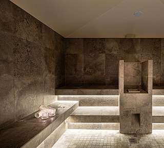 Modern sauna with stone walls