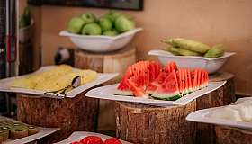Platters of fruit on wooden stands