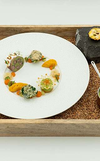 Gourmet dish on a wooden tray